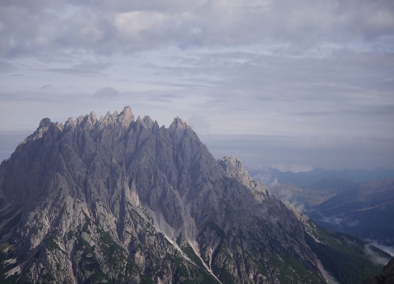 Mountain ridge beneath a cloudy sky
